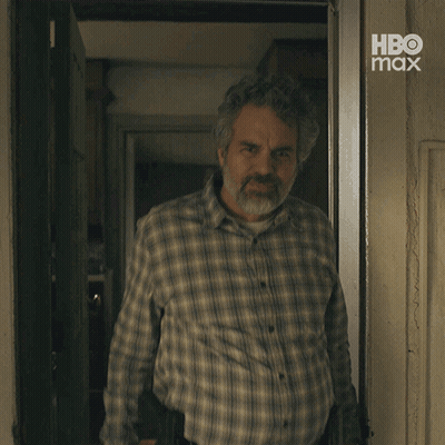 A Man With A Beard Wearing A Plaid Shirt With Hbo Max Written On The Bottom GIF