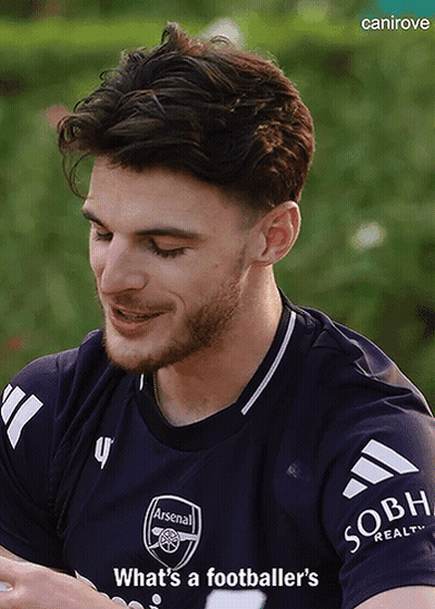 A Man With A Beard Wearing A Purple Arsenal Jersey GIF