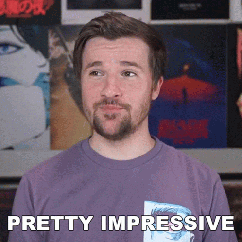 A Man With A Beard Wearing A Purple Shirt Says Pretty Impressive GIF