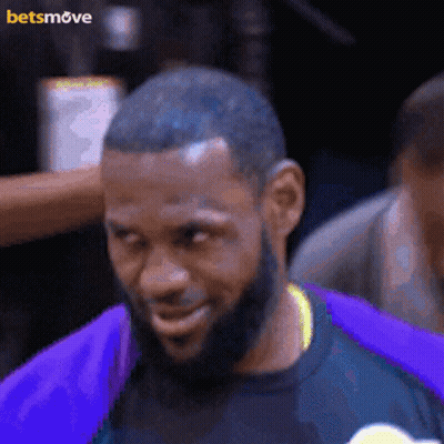 A Man With A Beard Wearing A Purple Shirt With A Betsmove Logo On The Bottom GIF