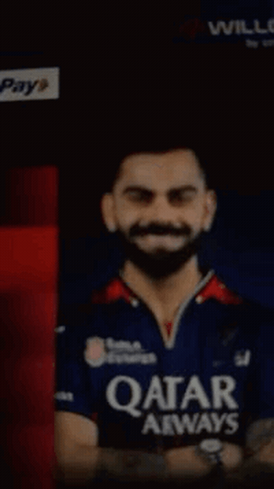 A Man With A Beard Wearing A Qatar Airways Shirt GIF
