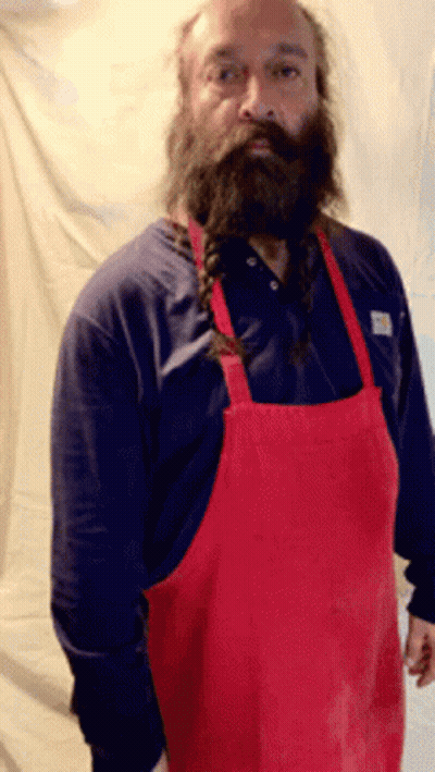 A Man With A Beard Wearing A Red Apron And A Blue Shirt GIF
