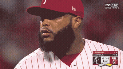 A Man With A Beard Wearing A Red Hat And A White And Red Striped Shirt GIF