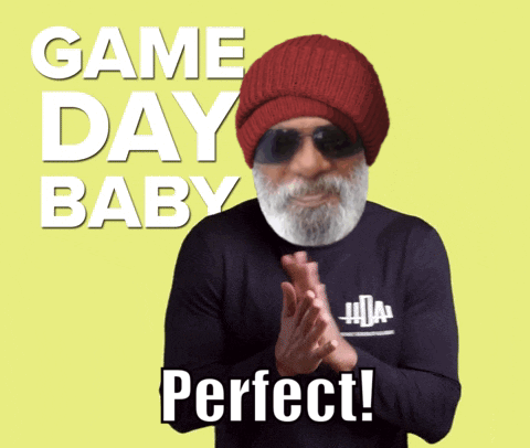 A Man With A Beard Wearing A Red Hat And Sunglasses Is Clapping In Front Of A Yellow Background That Says Game Day Baby GIF