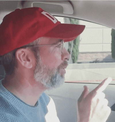 A Man With A Beard Wearing A Red Hat With A Letter D On It GIF