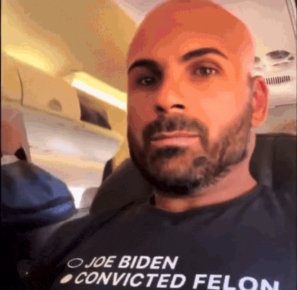 A Man With A Beard Wearing A Shirt That Says Joe Biden Convicted Felon GIF