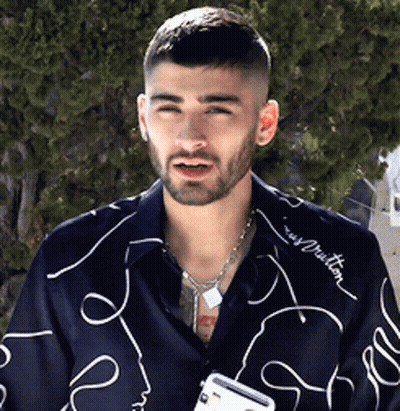 A Man With A Beard Wearing A Shirt That Says Louis Vuitton On It GIF