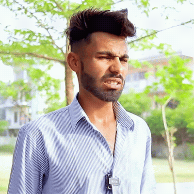 A Man With A Beard Wearing A Striped Shirt Has A Tag Around His Neck That Says ' A ' On It GIF