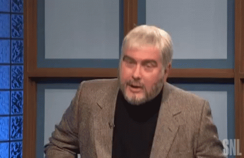 A Man With A Beard Wearing A Suit And Black Turtleneck Is On Snl GIF