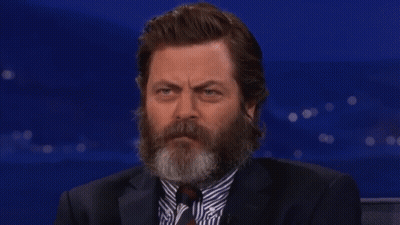 A Man With A Beard Wearing A Suit And Tie Is Smiling GIF
