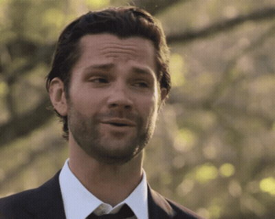 A Man With A Beard Wearing A Suit And Tie Is Smiling GIF