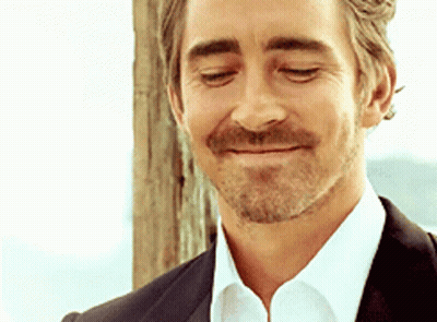 A Man With A Beard Wearing A Suit And White Shirt Is Smiling With His Eyes Closed GIF