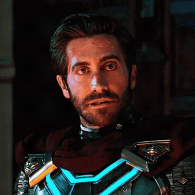 A Man With A Beard Wearing A Superhero Costume Is Looking At The Camera . GIF