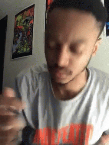 A Man With A Beard Wearing A T-Shirt That Says ' Meat ' GIF