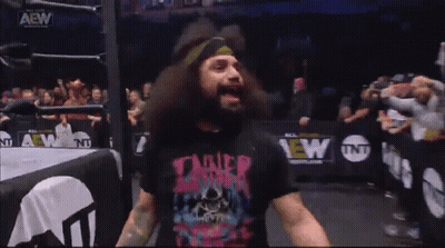 A Man With A Beard Wearing A T-Shirt That Says Tainer GIF