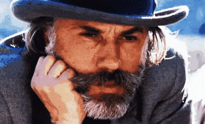 A Man With A Beard Wearing A Top Hat And A Gray Suit GIF