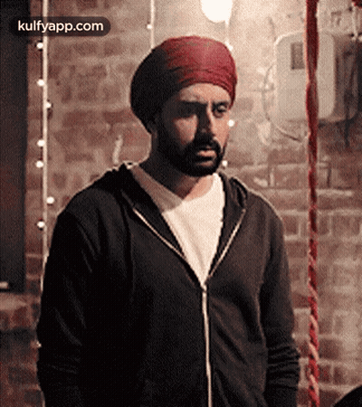 A Man With A Beard Wearing A Turban And A Black Jacket GIF