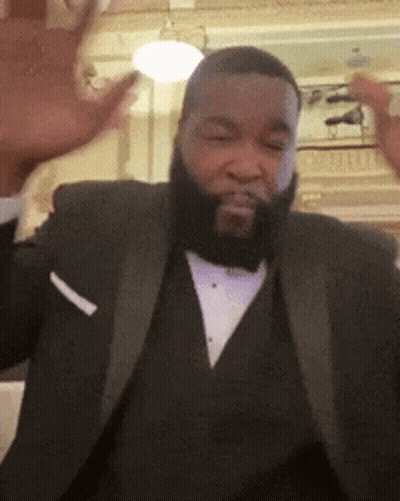 A Man With A Beard Wearing A Tuxedo And A White Pocket Square GIF