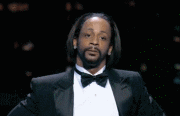 A Man With A Beard Wearing A Tuxedo And Bow Tie Is Making A Funny Face . GIF