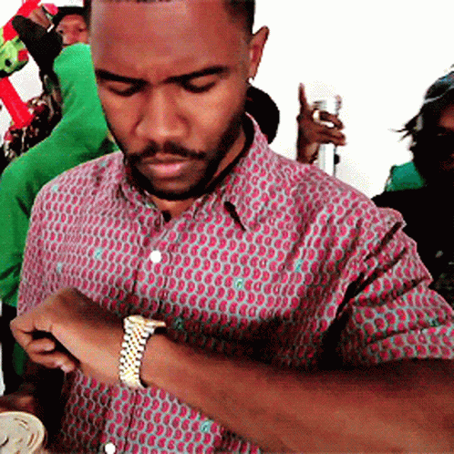 A Man With A Beard Wearing A Watch Looks At His Watch GIF