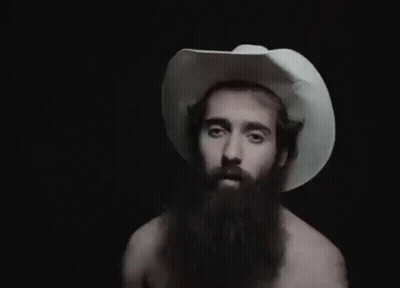A Man With A Beard Wearing A White Cowboy Hat . GIF