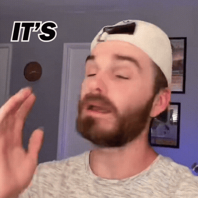 A Man With A Beard Wearing A White Hat And A Grey Shirt Says It 'S .. GIF