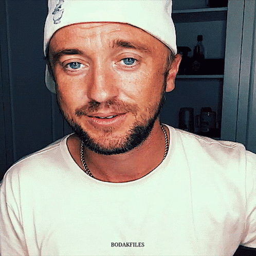 A Man With A Beard Wearing A White Hat And A White T-Shirt With The Word Bodakfiles On It GIF
