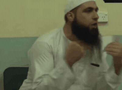 A Man With A Beard Wearing A White Hat And White Shirt GIF