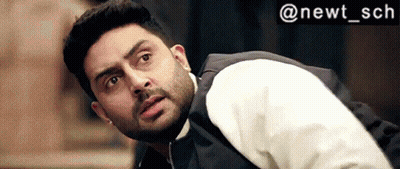 A Man With A Beard Wearing A White Shirt And A Black Vest Is Looking Up . GIF