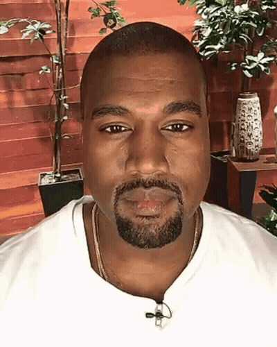 A Man With A Beard Wearing A White Shirt And A Gold Chain GIF