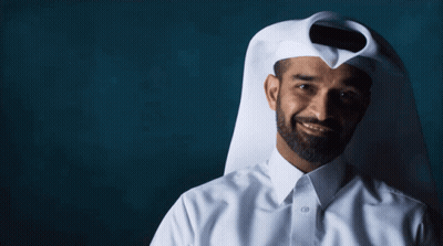 A Man With A Beard Wearing A White Shirt And A Scarf Covering His Face GIF