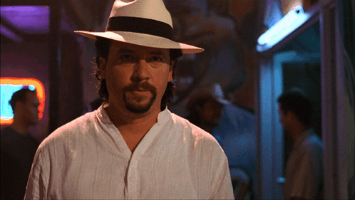 A Man With A Beard Wearing A White Shirt And A White Hat GIF