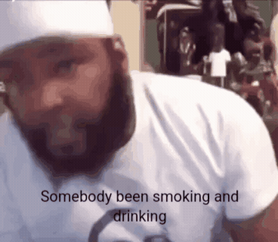A Man With A Beard Wearing A White Shirt Says Somebody Been Smoking And Drinking . GIF