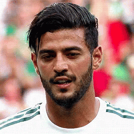 A Man With A Beard Wearing A White Shirt With Green Stripes GIF