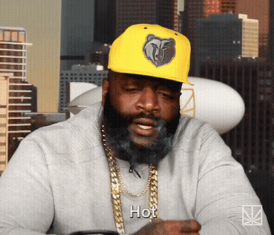 A Man With A Beard Wearing A Yellow Hat That Says Hot On It GIF