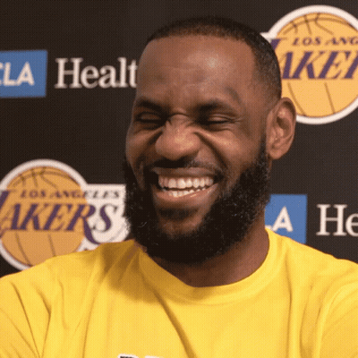 A Man With A Beard Wearing A Yellow Lakers Shirt Smiles GIF