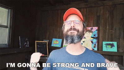 A Man With A Beard Wearing An Orange Hat And Glasses Says I 'M Gonna Be Strong And Brave GIF