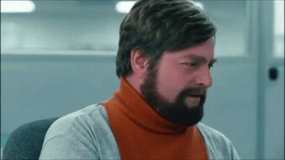 A Man With A Beard Wearing An Orange Turtleneck Sweater GIF