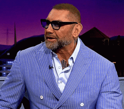 A Man With A Beard Wearing Glasses And A Blue Striped Jacket GIF