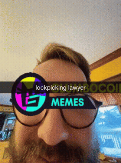 A Man With A Beard Wearing Glasses And A Sign That Says Lockpicking Lawyer GIF