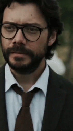 A Man With A Beard Wearing Glasses And A Suit And Tie GIF