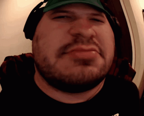 A Man With A Beard Wearing Headphones And A Hat GIF