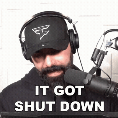 A Man With A Beard Wearing Headphones And A Hat Says It Got Shut Down GIF
