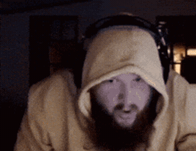 A Man With A Beard Wearing Headphones And A Hooded Sweatshirt GIF