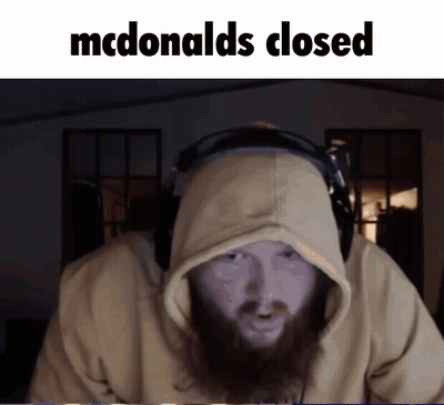 A Man With A Beard Wearing Headphones And A Hoodie Says Mcdonald 'S Closed GIF