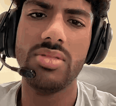 A Man With A Beard Wearing Headphones And A Microphone Around His Neck . GIF