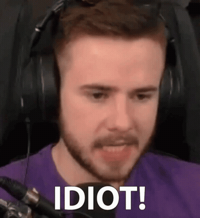 A Man With A Beard Wearing Headphones And A Purple Shirt Is Making A Funny Face . GIF