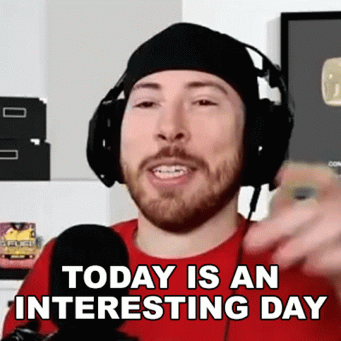 A Man With A Beard Wearing Headphones And A Red Shirt Says Today Is An Interesting Day GIF