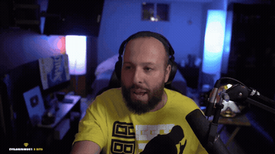 A Man With A Beard Wearing Headphones And A Yellow T-Shirt With The Letters Bb On It GIF