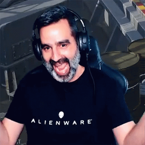 A Man With A Beard Wearing Headphones And An Alienware T-Shirt . GIF